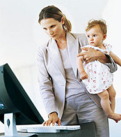 woman working and taking care of child