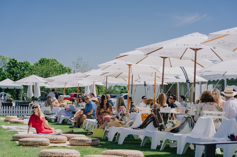 A group of people sitting outside under umbrellas

Description automatically generated with low confidence