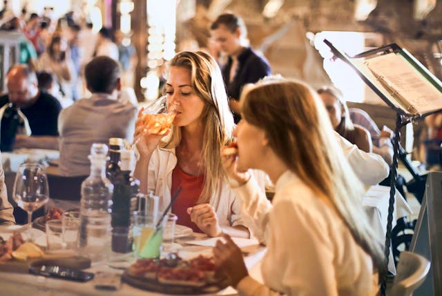 Two women eating and drinking in a restaurant
