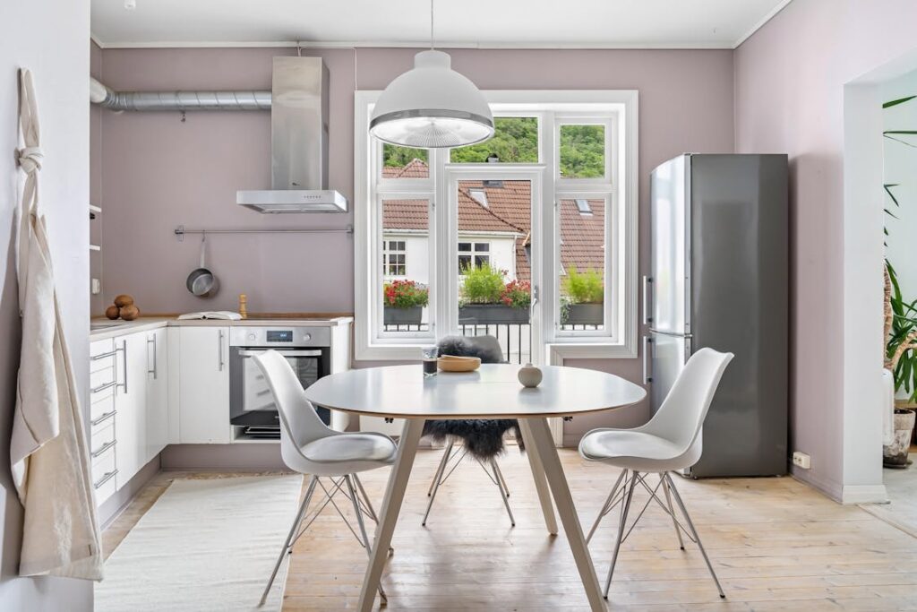 Free A kitchen with pink walls and white cabinets Stock Photo