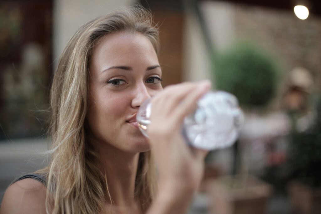 Photo by Andrea Piacquadio: https://www.pexels.com/photo/selective-focus-photo-of-smiling-woman-drinking-water-from-a-plastic-bottle-3763929/