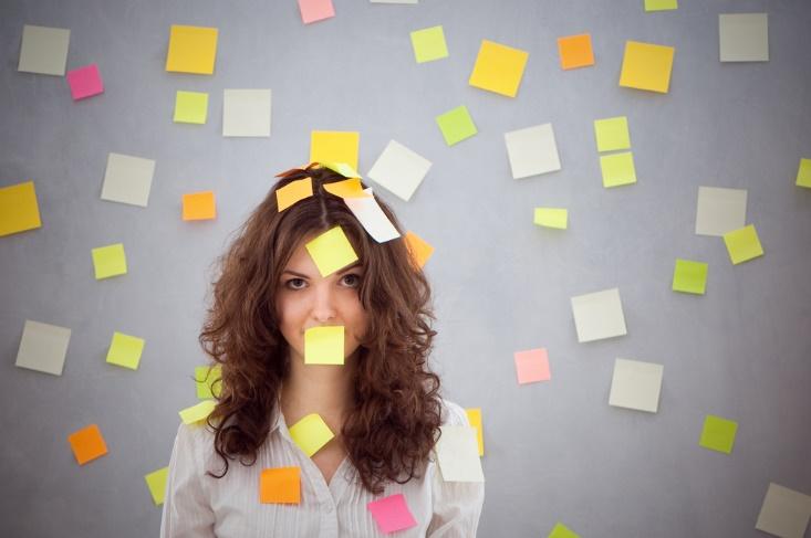 A person with many sticky notes on her face Description automatically generated