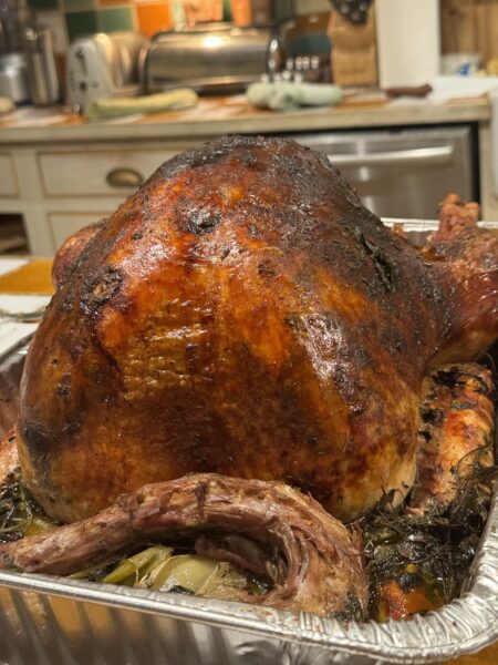 Thanksgiving table setting with candles, plates, and glasses of wine — elegant but barely touched