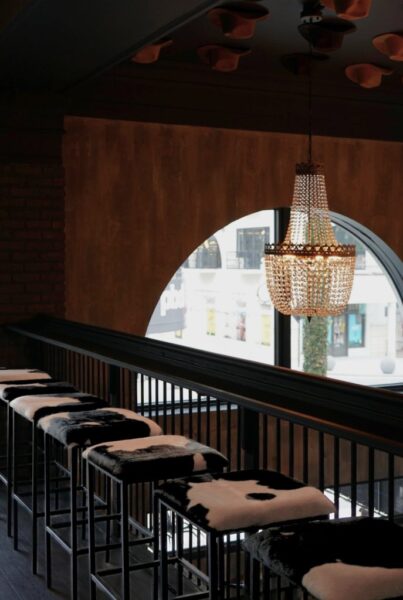 Cowhide stools, warm lighting, and major Nashville energy—this is where the night starts.