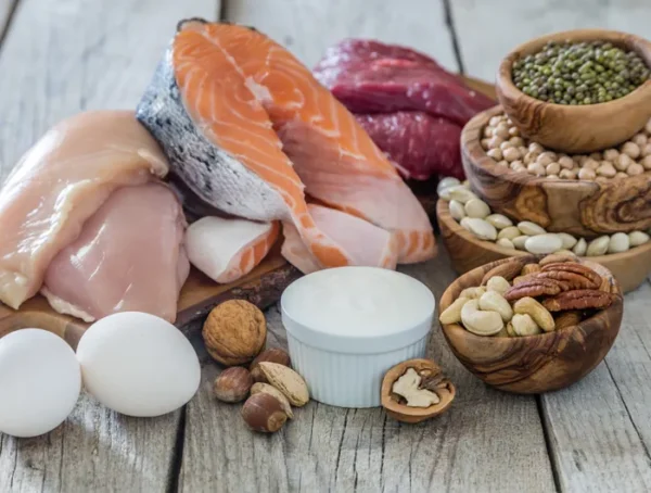 High protein foods including chicken fish eggs beans and nuts showing the difference between whole foods and processed protein products