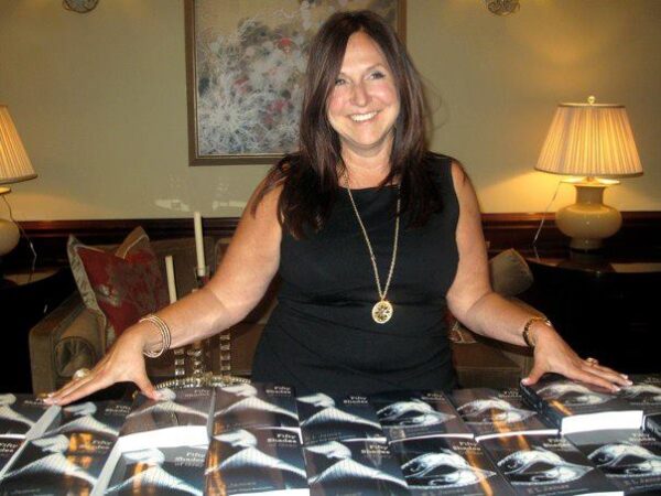 Stacy Geisinger surrounded by Fifty Shades of Grey books during her viral 2012 blog moment on StacyKnows