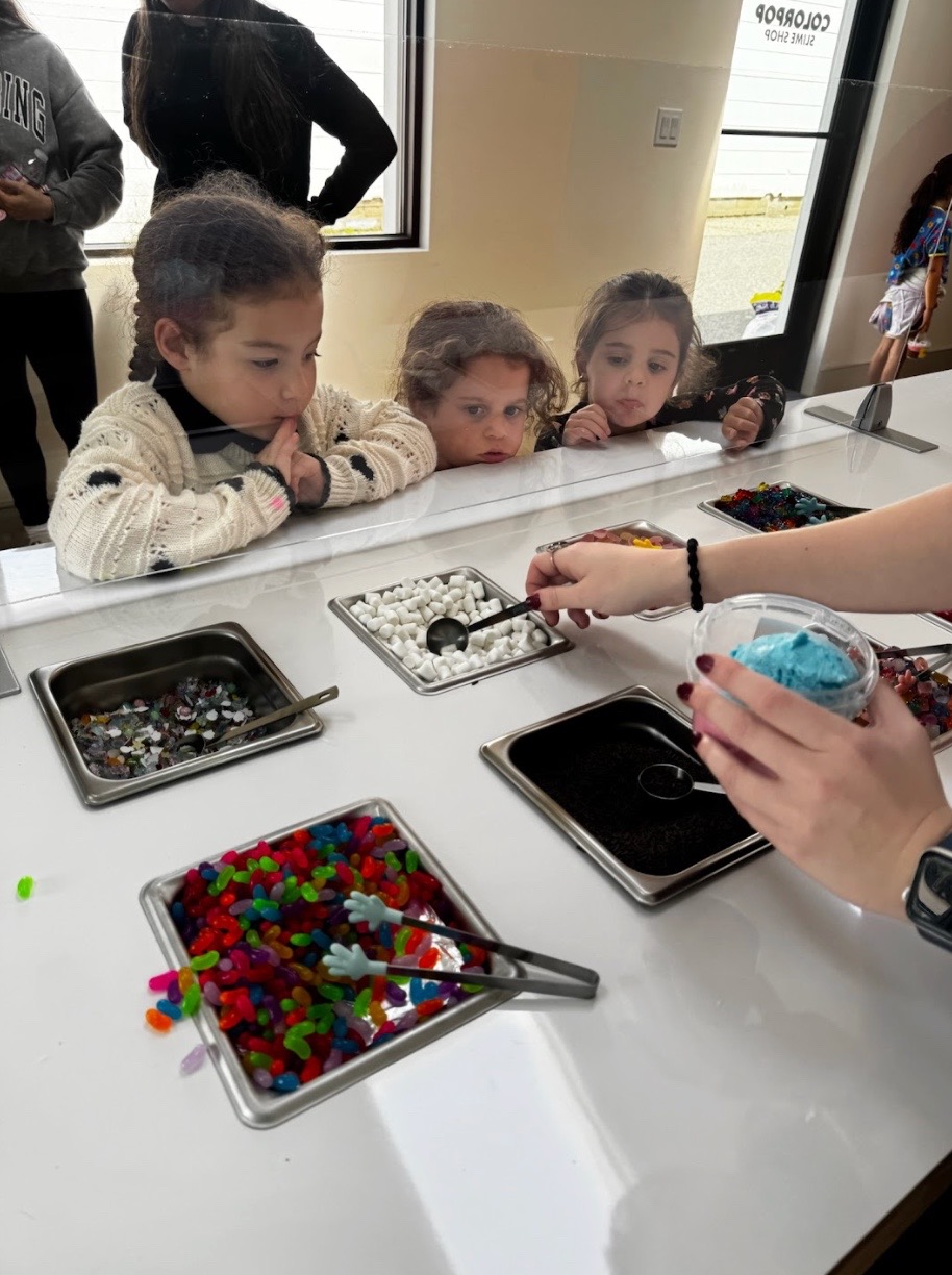 Children choosing slime toppings at ColorPop Slime Shop in Southampton.