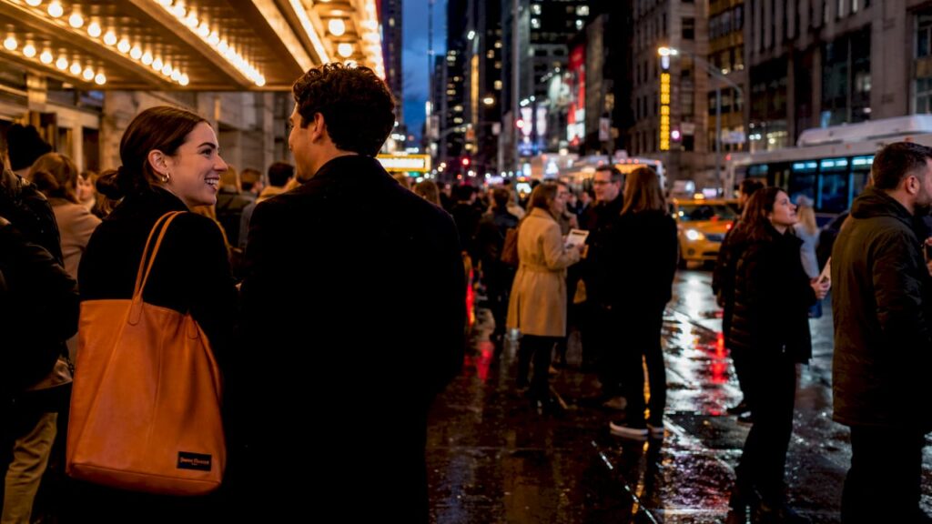 Broadway theater marquee with crowd at night