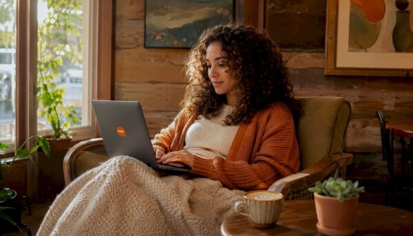 Woman browsing local businesses on laptop in café