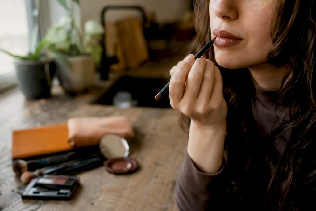 Close-up of lipstick bleeding repair with cotton swab