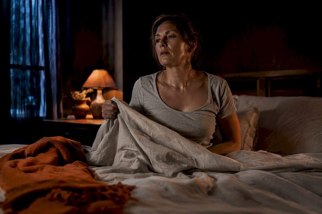 Woman cooling down during a night hot flash