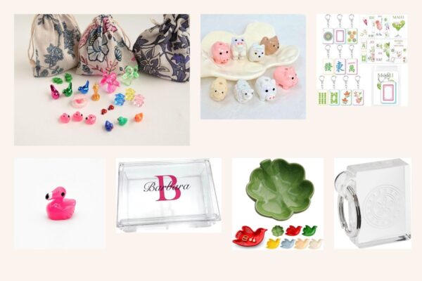 Flat-lay of tiny mahjong trinkets, a bird dish and acrylic tile keychains