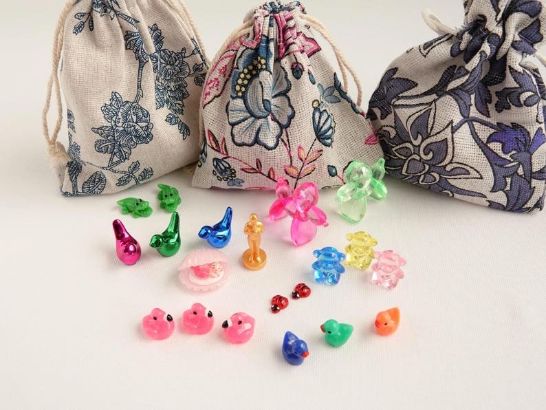 Tiny mahjong trinkets, ducks, birds and ladybugs, with floral drawstring pouches